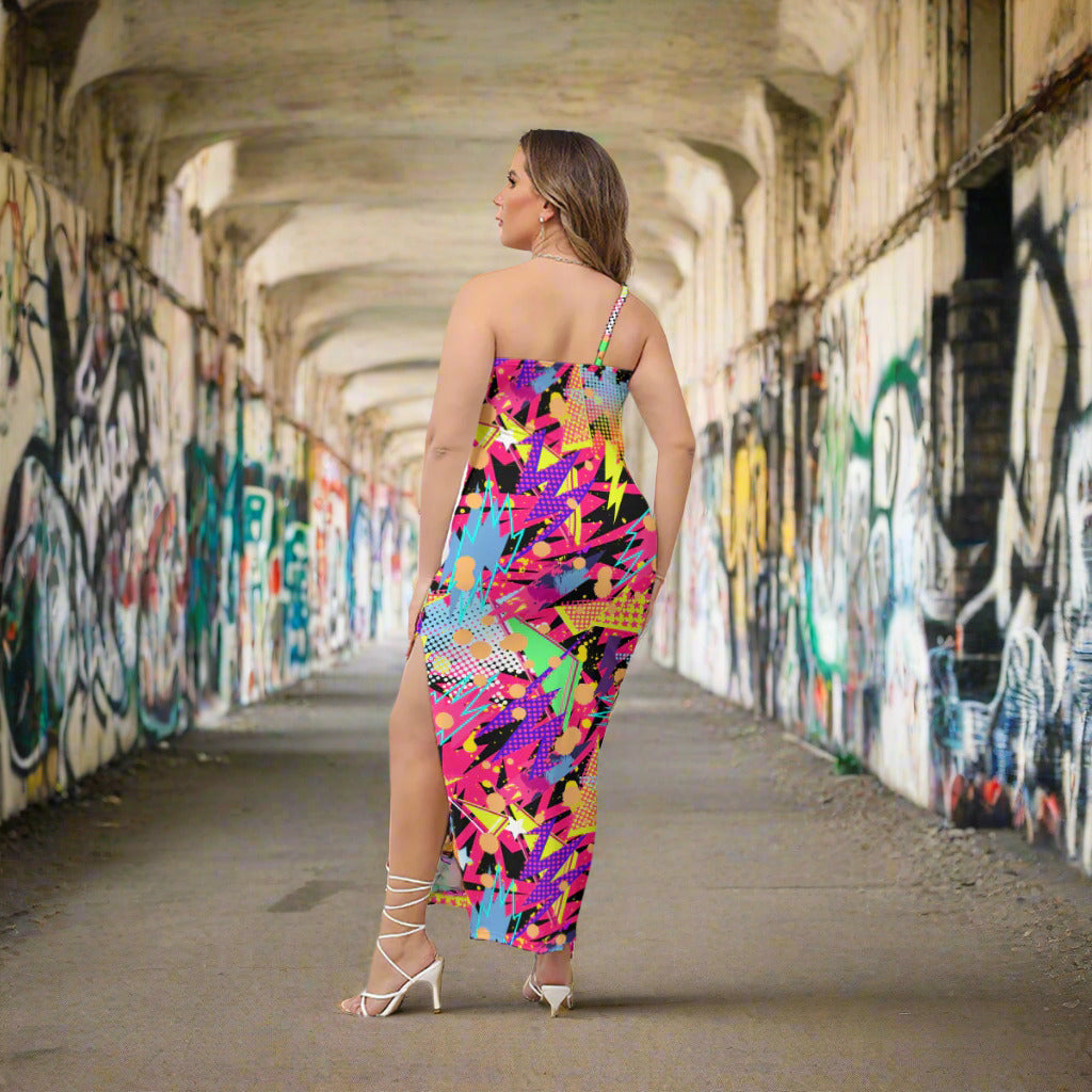 Woman wearing a colorful dress with abstract patterns in an outdoor setting.