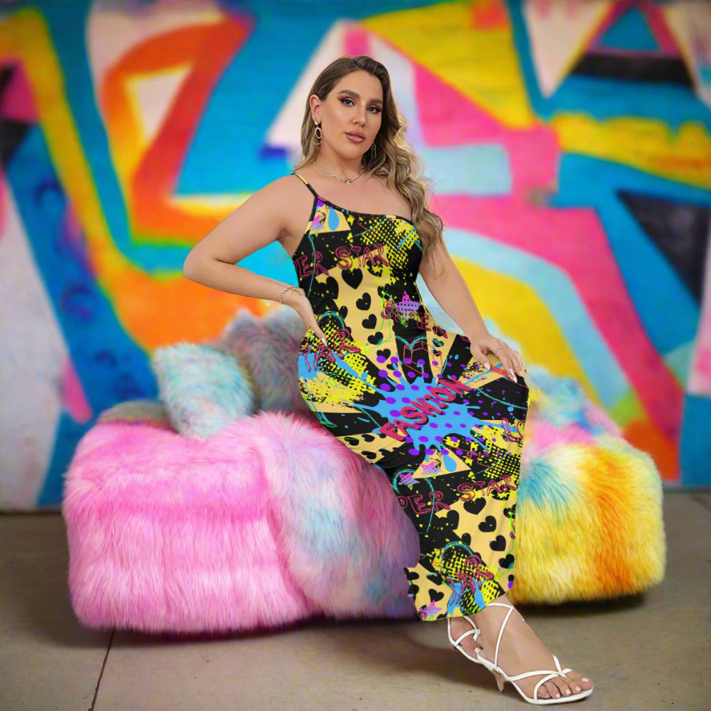 Woman wearing a colorful tie-dye jumpsuit sitting on a couch.