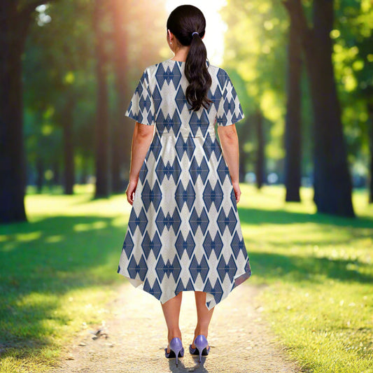 Woman wearing a blue and white patterned dress on a plain background